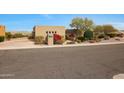 Tan stucco house with a driveway and mature trees at 15234 E Sundown Dr, Fountain Hills, AZ 85268