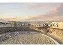 Welcome to Desert Moon Estates, as displayed on the community's stone and metal monument sign at sunrise at 1559 S 239Th Dr, Buckeye, AZ 85326