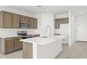 Modern kitchen featuring an island, stainless steel appliances, and ample cabinetry at 1559 S 239Th Dr, Buckeye, AZ 85326