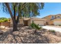 One-story house with a two-car garage and mature tree at 16411 N 163Rd Dr, Surprise, AZ 85388