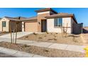 Newly built home with a two-car garage and small front yard at 18398 W Monte Lindo Ln, Surprise, AZ 85387