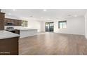 Modern kitchen with island, stainless steel appliances, and wood cabinets at 18398 W Monte Lindo Ln, Surprise, AZ 85387