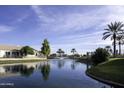 Serene community lake reflecting surrounding homes at 20315 N 106Th Ave, Peoria, AZ 85382