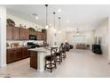 Kitchen boasts an island with seating, granite counters, and ample cabinetry at 24211 N 168Th Ln, Surprise, AZ 85387
