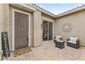 Cozy front porch featuring a seating area with stylish outdoor furniture at 25891 N 104Th Dr, Peoria, AZ 85383