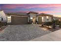Single story home with a brown garage door and landscaped front yard at 27453 W Wahalla Ln, Buckeye, AZ 85396