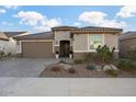 Single-story home with brown garage door and landscaped yard at 27453 W Wahalla Ln, Buckeye, AZ 85396