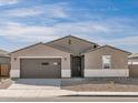 Charming single-story home featuring a two-car garage and low-maintenance desert landscaping at 37073 W La Paz St, Maricopa, AZ 85138