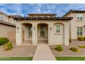 Front view of a two-story home with arched entryway and landscaping at 4159 E Pony Ln, Gilbert, AZ 85295