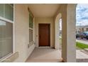 Covered front porch with dark brown door and sidelights at 4159 E Pony Ln, Gilbert, AZ 85295