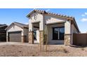 Single-story stucco home featuring stone accents, a brown roof, and a well-manicured, low-maintenance front yard at 42104 N Golden Trl, San Tan Valley, AZ 85140