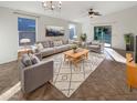 Bright living room featuring a comfortable sofa and large windows at 6038 S Connie Ln, Gilbert, AZ 85298
