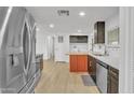 Updated kitchen featuring stainless steel appliances and orange island at 7648 E Holmes Ave, Mesa, AZ 85209