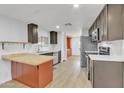 Open concept kitchen with island and stainless steel appliances at 7648 E Holmes Ave, Mesa, AZ 85209