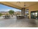 Covered patio with outdoor kitchen and seating area at 10630 E Cactus View Cir, Gold Canyon, AZ 85118