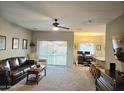 Spacious living room with leather furniture and view of pool at 10660 W Monaco Blvd, Arizona City, AZ 85123