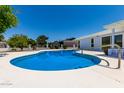 Inviting kidney-shaped pool with a large patio area at 10826 W Loma Blanca Dr, Sun City, AZ 85351