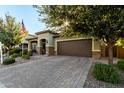 One-story home with a brown garage door and nicely landscaped front yard at 11047 E Tupelo Ave, Mesa, AZ 85212