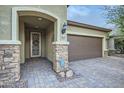 Front entry with stone accents and a decorative door at 11047 E Tupelo Ave, Mesa, AZ 85212