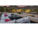 Relaxing rooftop terrace with sectional seating, fire pit, and mountain views at 12067 N 135Th Way, Scottsdale, AZ 85259