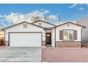 Newly built home with white siding, brick accents, and a two-car garage at 1217 S Desert View Pl, Apache Junction, AZ 85120