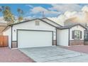 Newly built home with white siding, brick accents, and a two-car garage at 1217 S Desert View Pl, Apache Junction, AZ 85120