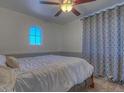 Bright bedroom with a ceiling fan and window at 1231 E Helena Dr, Phoenix, AZ 85022