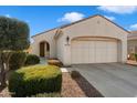 Front view of a beige house with a two-car garage and landscaping at 12947 W Chapala Dr, Sun City West, AZ 85375