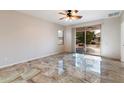 Bright living room with tile floors and sliding glass doors at 12947 W Chapala Dr, Sun City West, AZ 85375