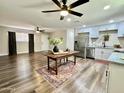 Open concept kitchen and living area with modern finishes and a farmhouse style table at 1325 W 7Th Ave, Mesa, AZ 85202