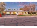 Mid-century modern home with updated garage and landscaping at 1422 W Colter St, Phoenix, AZ 85013