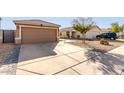 Two-car garage and driveway of a single-story house at 15725 W Post Dr, Surprise, AZ 85374