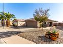 House exterior with a landscaped front yard and walkway at 15725 W Post Dr, Surprise, AZ 85374