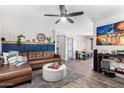 Living room with a brown sectional sofa and wood-look floors at 15725 W Post Dr, Surprise, AZ 85374