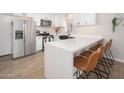 Modern kitchen with white cabinets, quartz countertops, and stainless steel appliances at 1624 W Lawrence Rd, Phoenix, AZ 85015