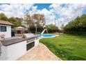 Modern outdoor kitchen with built-in grill, perfect for summer barbecues at 1624 W Lawrence Rd, Phoenix, AZ 85015