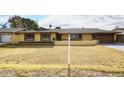 House exterior featuring a landscaped lawn and attached garage at 1707 E Mclellan Blvd, Phoenix, AZ 85016