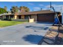 House exterior showcasing a large driveway and basketball hoop at 1707 E Mclellan Blvd, Phoenix, AZ 85016