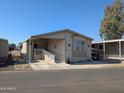 Tan mobile home with carport and ramp access at 17200 W Bell Rd # 1599, Surprise, AZ 85374