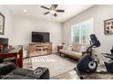 Home office featuring a TV, exercise bike, and wood furniture at 17502 W Blue Sky Dr, Surprise, AZ 85387