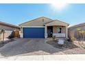 New single-story home with blue garage door and landscaped yard at 17645 W Jackson St, Goodyear, AZ 85338