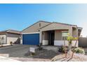 New single-story home with blue garage door and landscaped yard at 17645 W Jackson St, Goodyear, AZ 85338