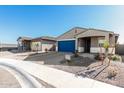 New single-story home with blue garage door and landscaped yard at 17645 W Jackson St, Goodyear, AZ 85338