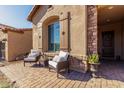 Relaxing front patio with wicker chairs and desert landscaping at 1820 N Bernard --, Mesa, AZ 85207