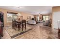 Open dining area with a wooden table and view into the living room at 18354 W Hatcher Rd, Waddell, AZ 85355