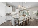 Modern kitchen with white cabinets, a large island, and stainless steel appliances at 19024 W Solano Dr, Litchfield Park, AZ 85340