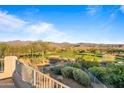 Scenic view of a golf course and mountains from a backyard patio at 19115 E Tonto Verde Dr, Rio Verde, AZ 85263