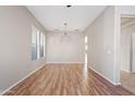 Empty dining room featuring wood-look floors and neutral walls at 19359 E Canary Way, Queen Creek, AZ 85142