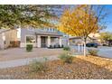 Two-story house with gray siding, fall foliage, and a driveway at 19359 E Canary Way, Queen Creek, AZ 85142