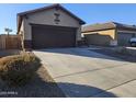 A two-car garage with a concrete driveway at 19422 N Smith Dr, Maricopa, AZ 85139